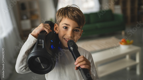 boy seven years old child hold microphone at home happy smile sing