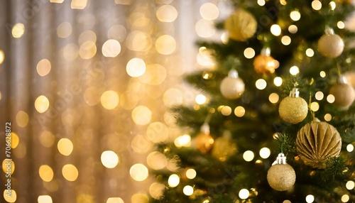 merry christmas and happy new year festive bright beautiful background decorated christmas tree on blurred background de focused lights gold bokeh