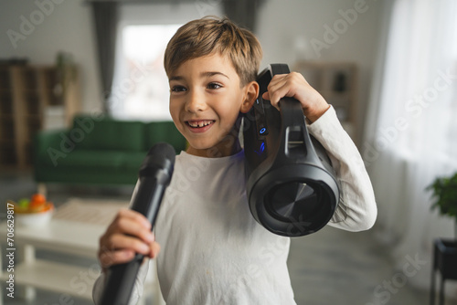 boy seven years old child hold microphone at home happy smile sing