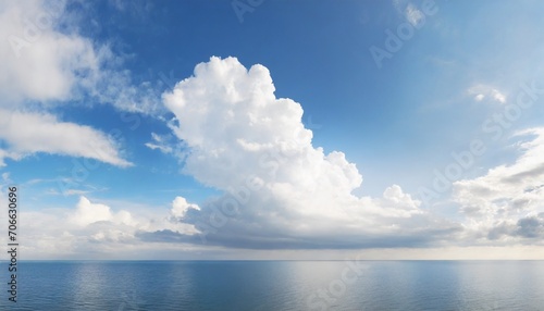 white cumulus clouds in blue sky over sea landscape big cloud above ocean water panorama horizon beautiful tropical sunny summer day seascape panoramic view cloudy weather cloudscape copy space