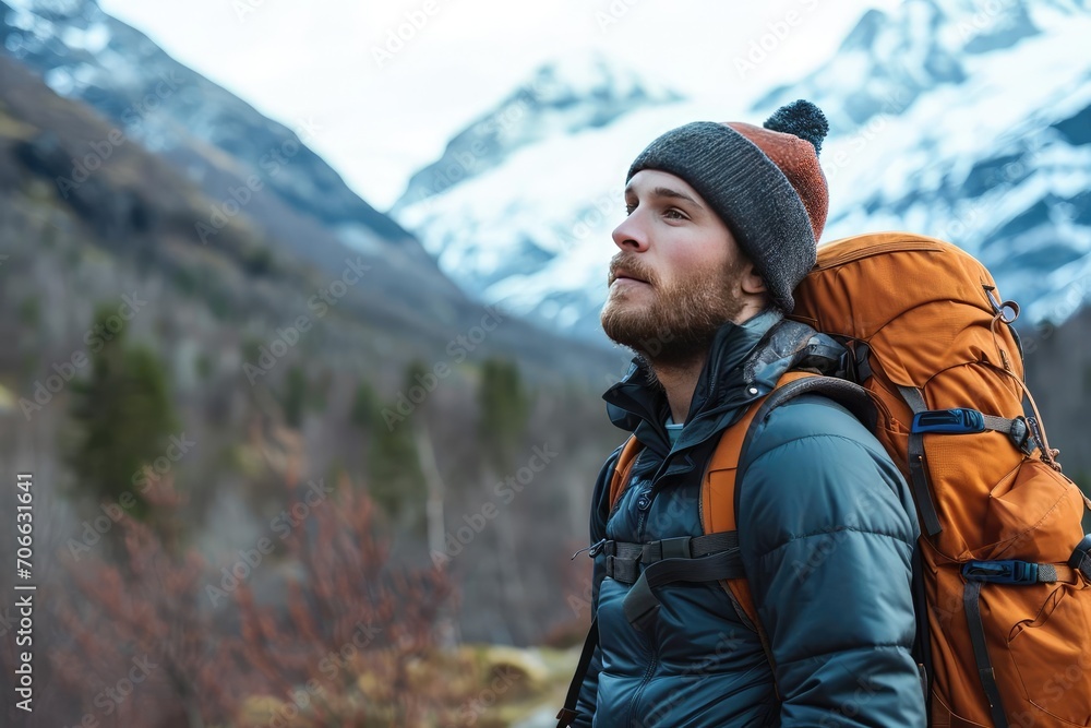 Rugged male model in outdoor gear Trekking through a mountainous landscape