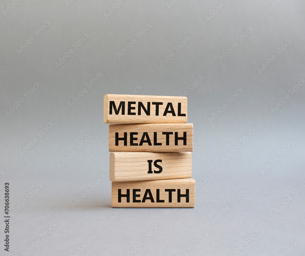 Mental Health symbol. Wooden blocks with words Mental Health is Health. Beautiful grey background. Medical and Health concept. Copy space.