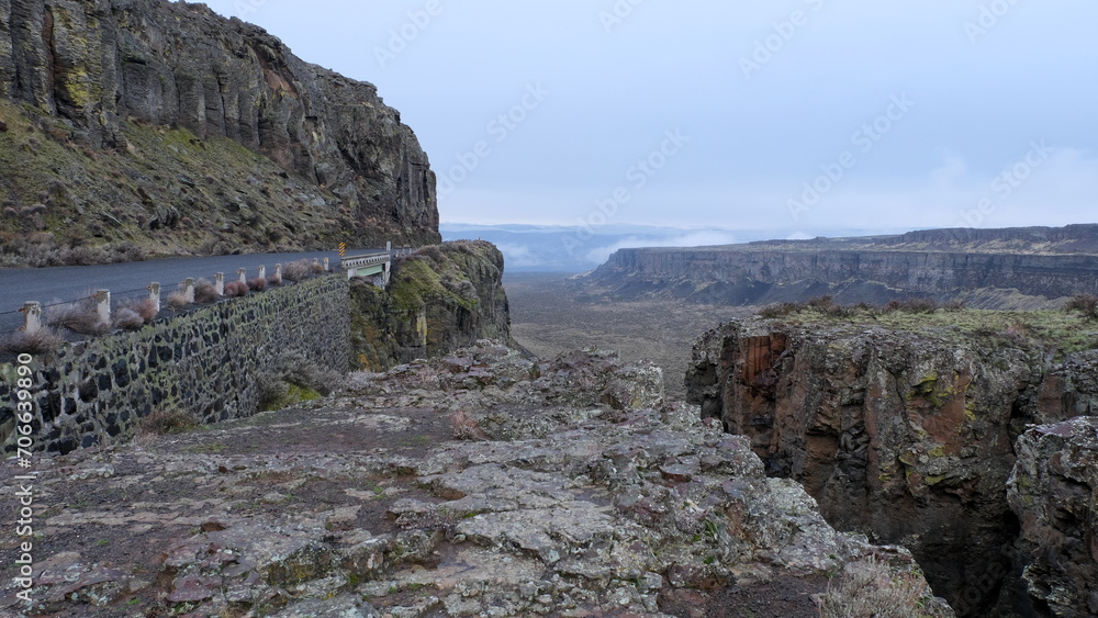 Landscape view of wide, flat bottomed canyon with steep rising rocky cliffs at Frenchman Coulee in Washington state, USA