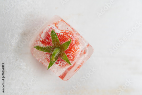Photographic shot of some tomatoes inside ice cube