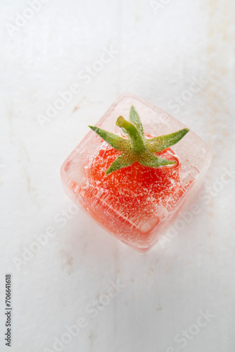 Photographic shot of some tomatoes inside ice cube