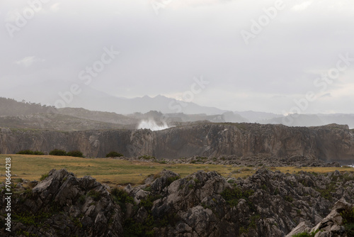Landscape of Bufones de Pria in Asturias coast on a cloudy day with rough seas and wave spray