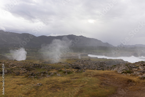 Asturias coast on a cloudy day at Bufones de Pria with rough seas and waves spray