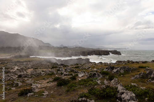 Landscape of Bufones de Pria in Asturias coast on a cloudy day with rough seas and wave spray