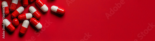 Banner with capsules on a red background. Design for vitamins, scientific articles, a place for text, copyspace