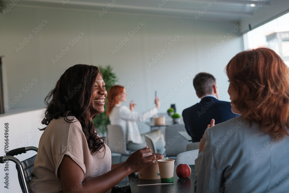 Group of businesspeople eating together during break time in a coworking room