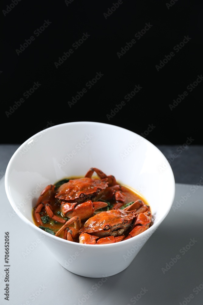 Delicious boiled crabs with sauce on table, space for text Delicious boiled crabs with sauce on table, space for text