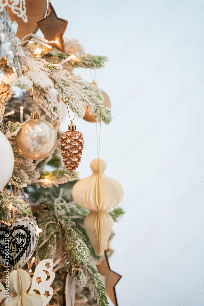Christmas decor in the house with a Christmas tree, artificial Christmas tree and toys with a garland close-up