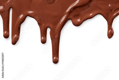 Tasty melted milk chocolate pouring down on white background photo