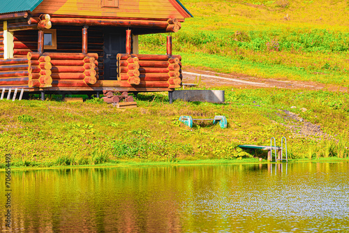 Wooden house on the shore of a pond  Corrected .