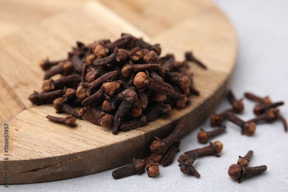 Pile of aromatic cloves on light table, closeup Pile of aromatic cloves on light table, closeup