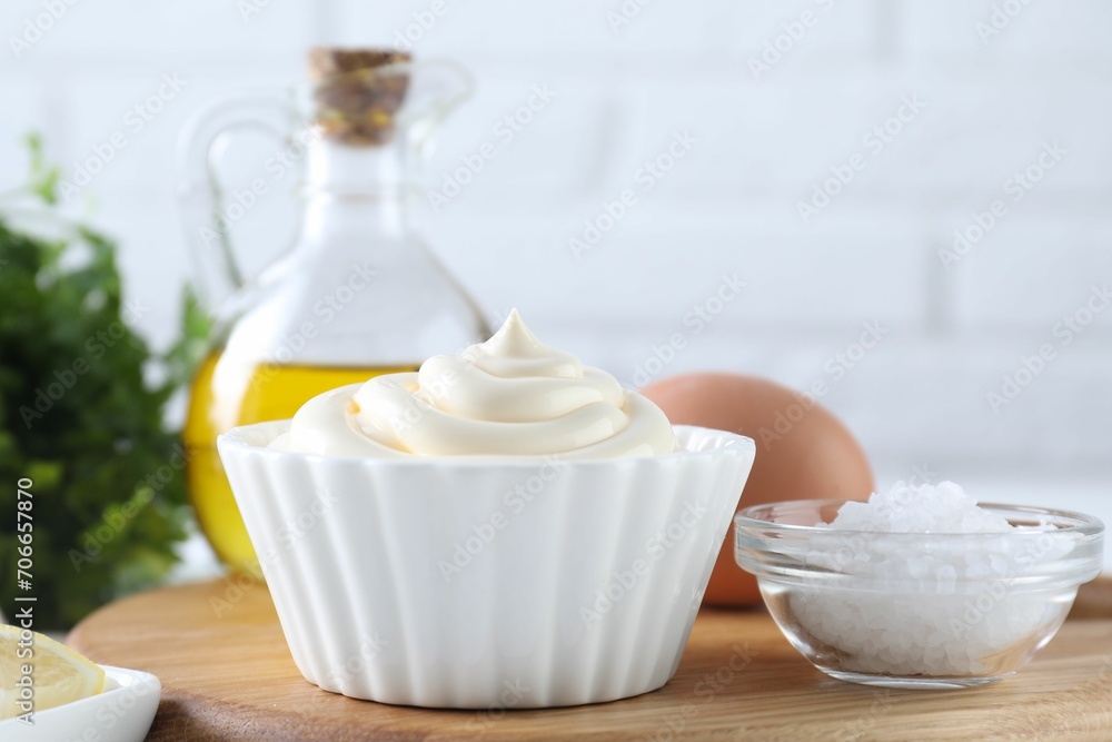 Fresh mayonnaise sauce in bowl and ingredients on table Fresh mayonnaise sauce in bowl and ingredients on table