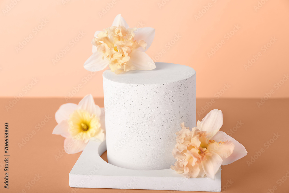 Decorative plaster podiums with narcissus flowers on nude background Decorative plaster podiums with narcissus flowers on nude background