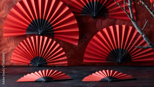 Chinese New Year festival decoration. Red paper fans against a dark background background. Traditional Lunar New Year paper art