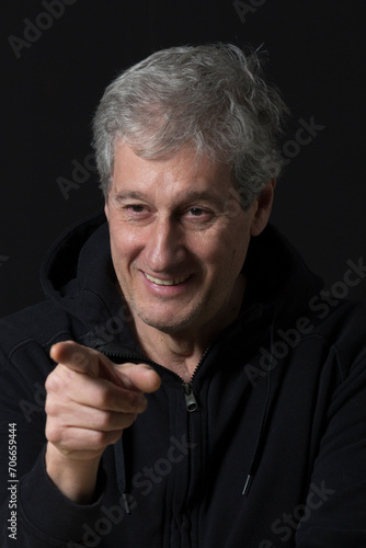 portrait of a mature man pointing his finger