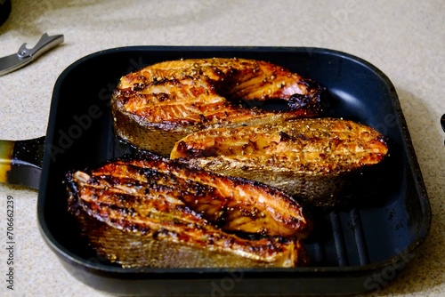 Grilled red fish, Grilled salmon steak , top view, fish steaks on the flame