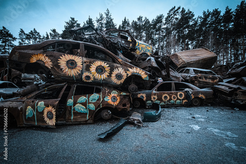 Cemetery of cars shot by Russian occupiers in the Ukrainian city of Bucha photo