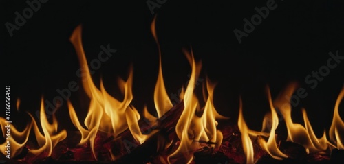  a close up of a fire in the dark with lots of orange and yellow flames coming out of the flames.