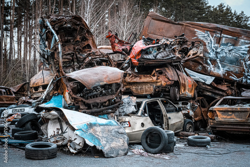 Cemetery of cars shot by Russian occupiers in the Ukrainian city of Bucha photo