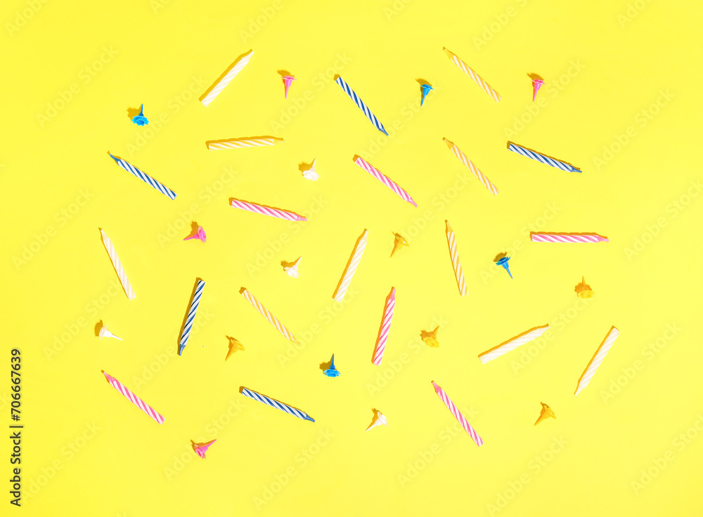 Colorful birthday candles on yellow background Colorful birthday candles on yellow background