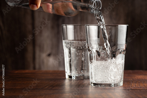 Glass of cold sparkling water. photo