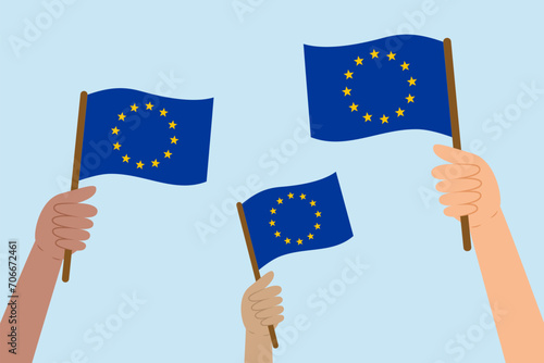 WebDiverse hands raising flags of the European Union. Vector illustration of the EU flags in flat style on blue background.