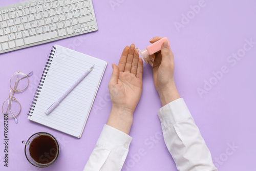 Woman applying hand sanitiz...