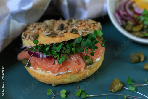 Gourmet Smoked Salmon Bagel With Fresh Herbs and Capers on a Stylish Ceramic Plate