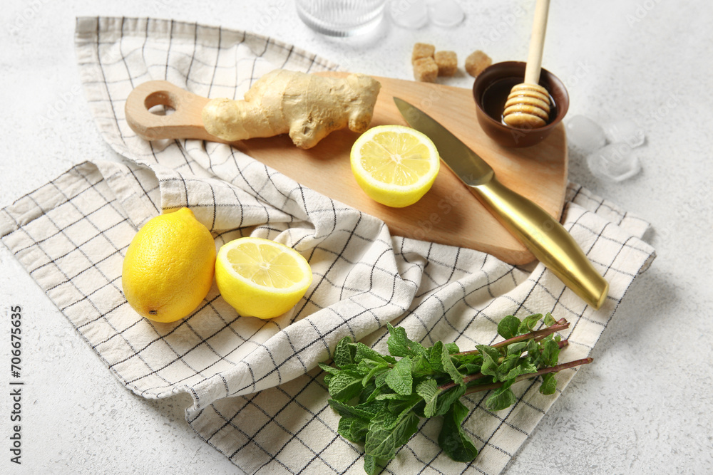 Wooden board with ingredients for preparing lemonade on grunge white background Wooden board with ingredients for preparing lemonade on grunge white background