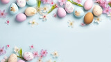 Easter frame of pastel eggs and spring blossom flowers on blue background. Religion tradition pattern. View from above. Flat lay. Greeting card. Copy space.