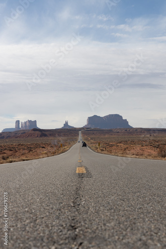 Road in the desert leading to rock formations