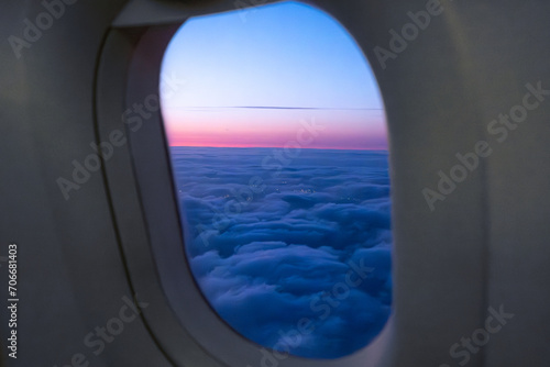 Amazing view of clouds and sunset in window on an airplane. 
