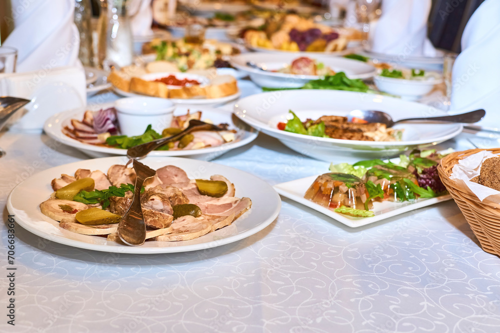 Served banquet festive table with various appetizers and salads