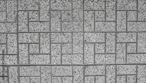 suelo de ladrillos grises y rugosos puestos de distintas formas generando líneas distintas  photo
