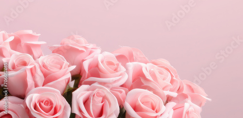 Greeting background with freshly pink roses flowerson a pink background . Festive banner for birthday, mother's day, March 8, anniversary. Copy space. Mock up.