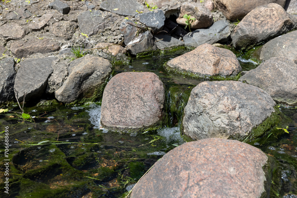 water flowing in a small narrow stream in summer