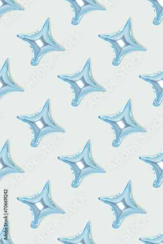 Repetitive pattern made of air star balloons on a blue background. Monochrome backdrop.