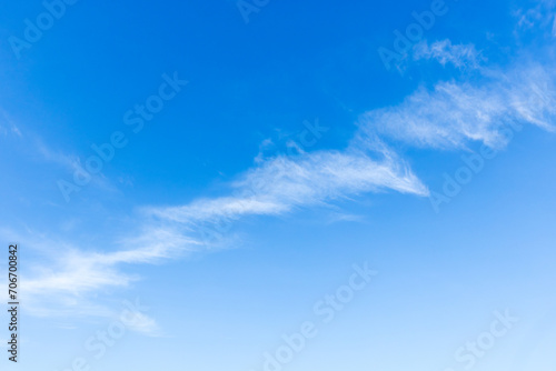 Line of cirrus clouds in blue sky, natural background photo texture
