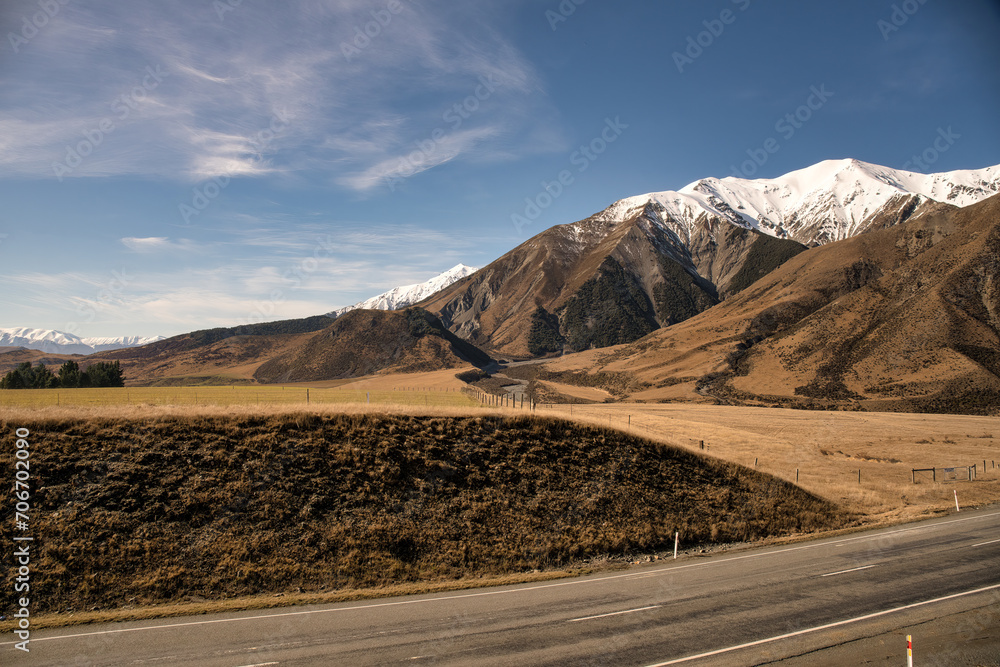 Lush farm land below the slopes of the snow capped southern alps