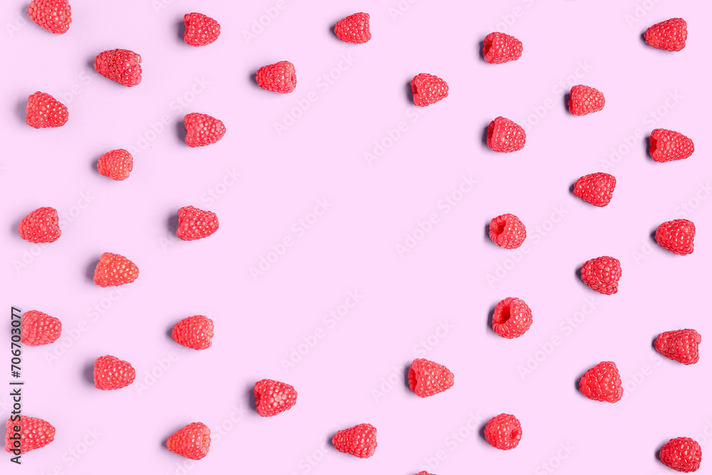 Frame made of fresh raspberries on pink background Frame made of fresh raspberries on pink background