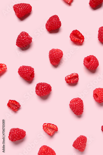 Many fresh raspberries on pink background