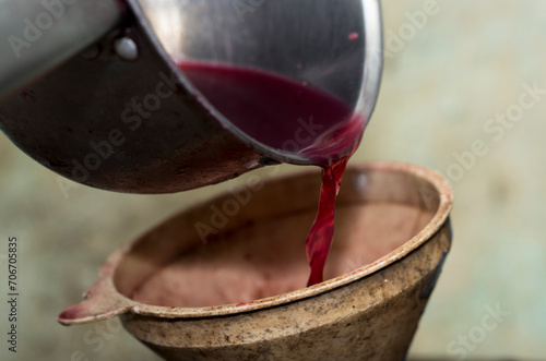 Wine making. Fresh grape juice is poured through a funnel into a barrel. Harvest home. Technology of wine production in Moldova.