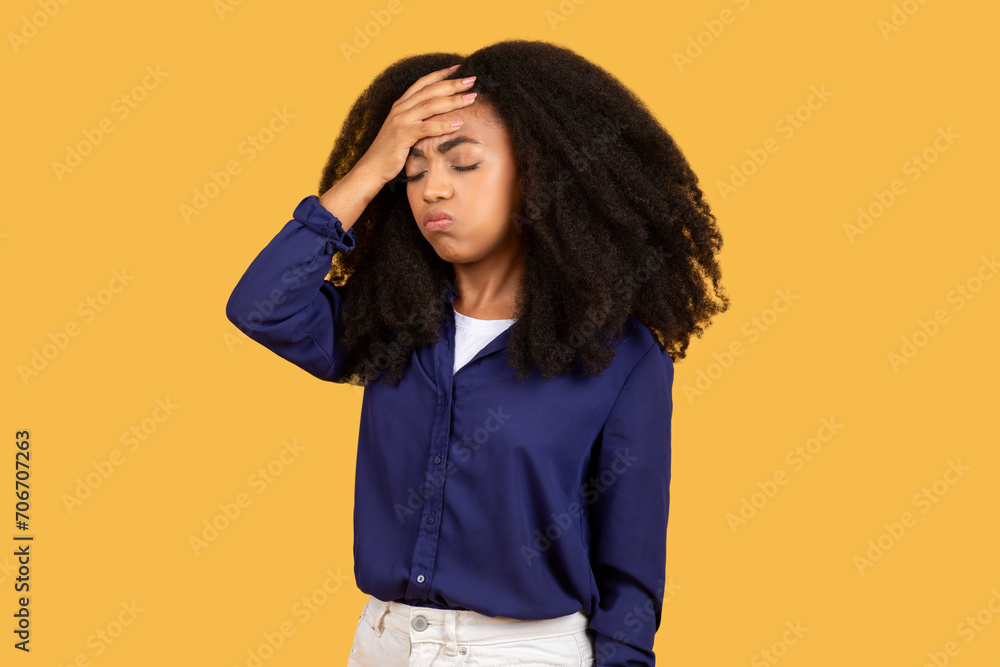 Black lady touching head having headache and fever symptoms, feeling bad over yellow background Black lady touching head having headache and fever symptoms, feeling bad over yellow background
