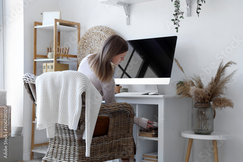 Young woman sitting at work...