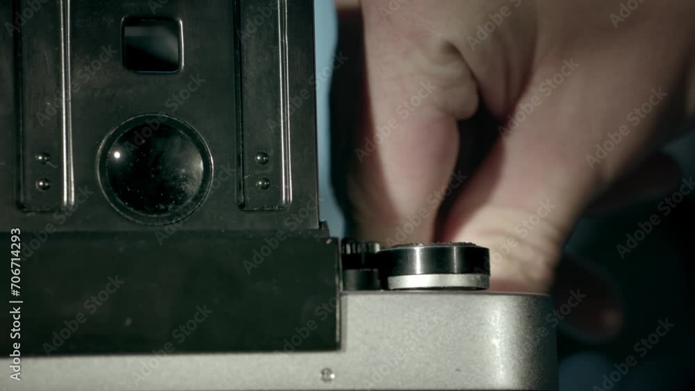 Master cocks the film camera shutter. Closeup of shutter operation. Slowmotion, footage 4K. Master cocks the film camera shutter. Closeup of shutter operation. Slowmotion, footage 4K.