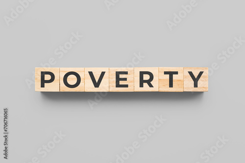 poverty wooden cubes on gray background photo